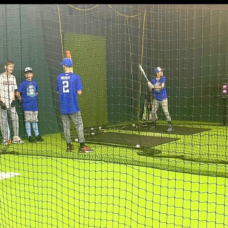 Youth batting practice with coaching